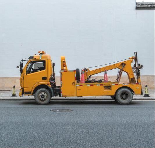Yellow tow truck preparing to haul a vehicle